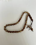 Brown beaded prayer beads on a white background