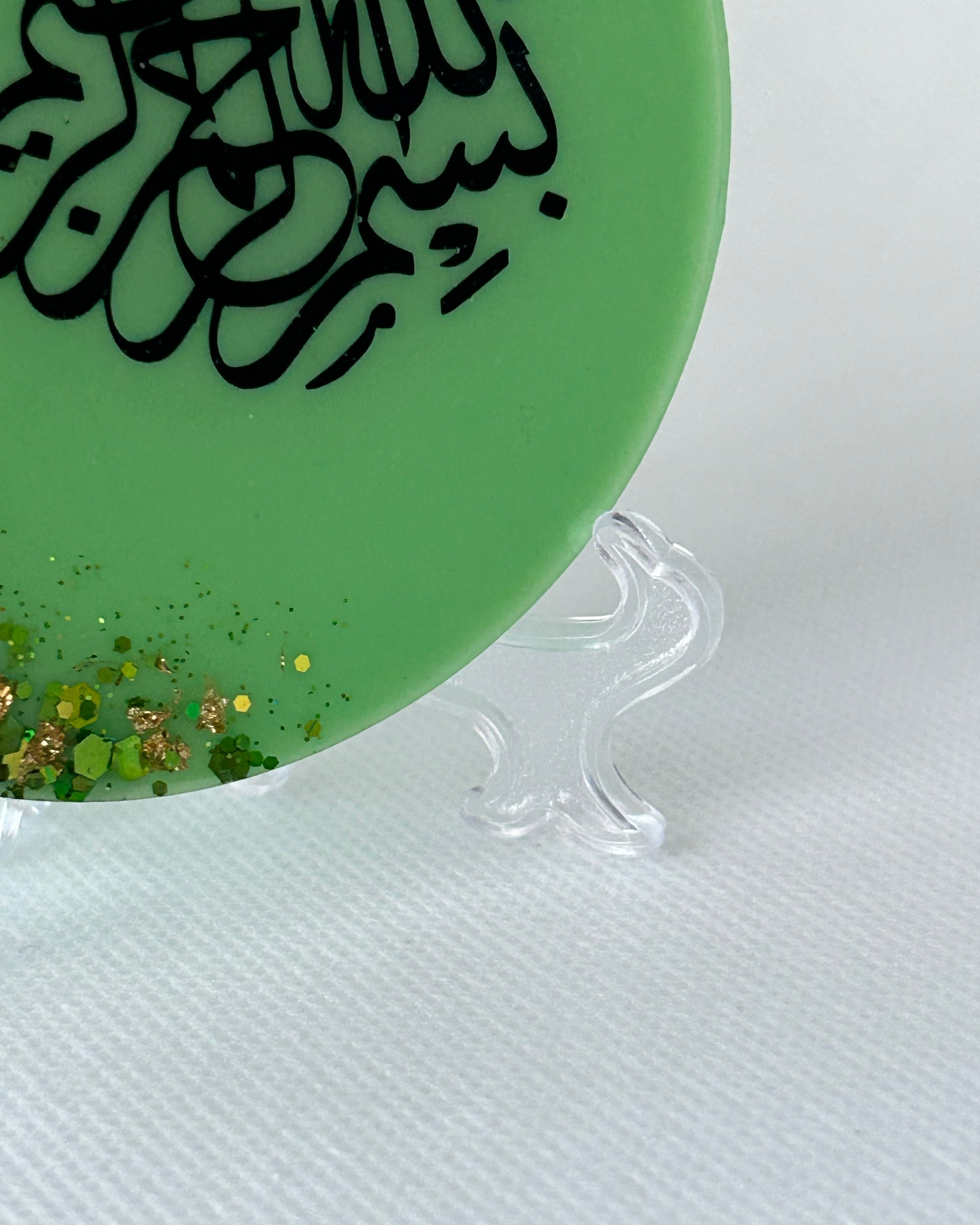 Green circular object with black text and gold specks on a white background