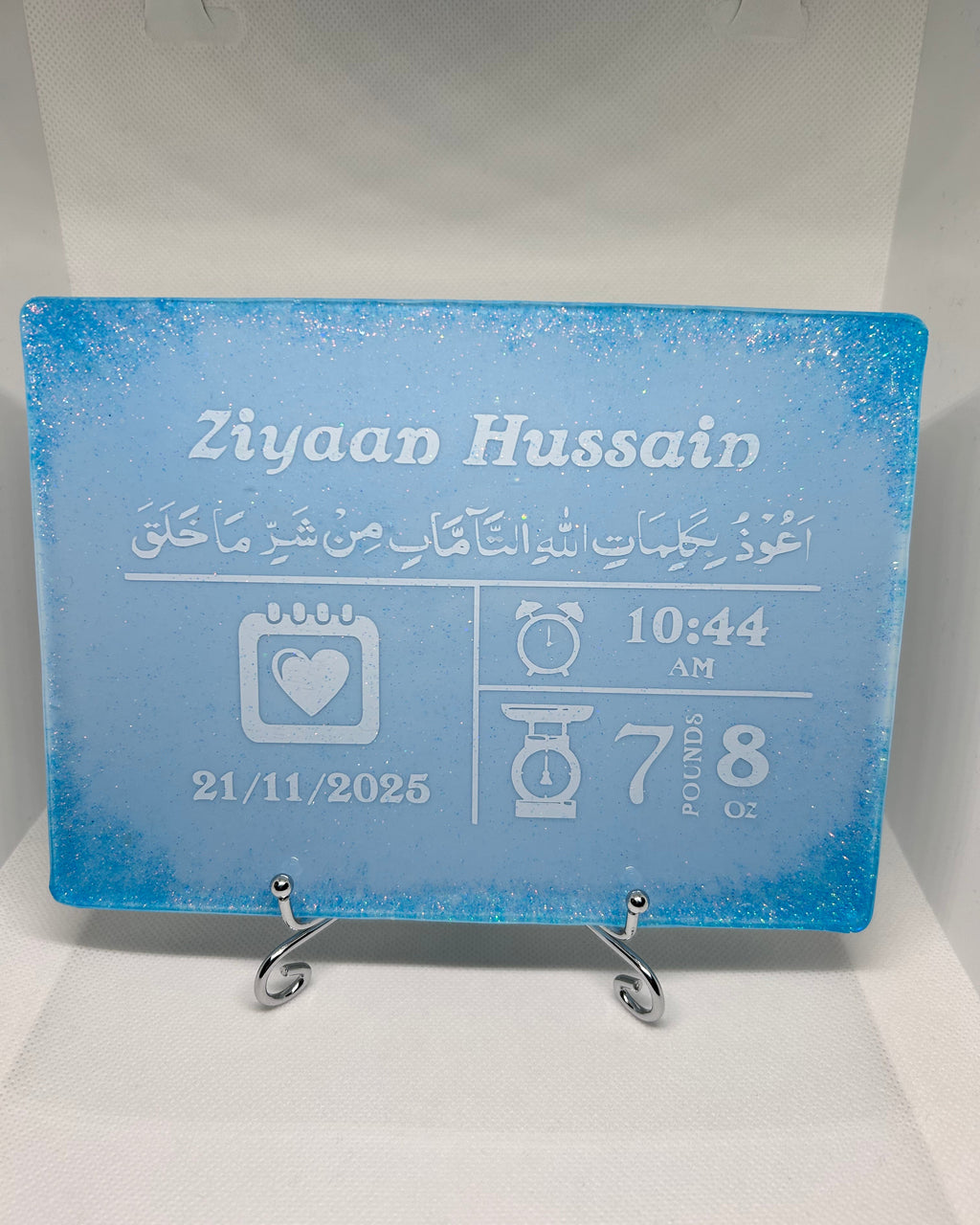 blue rectangle baby birth stat personalised resin plaque baby keepsake with personalised text in white and blue glitter in all for corner on a white background
