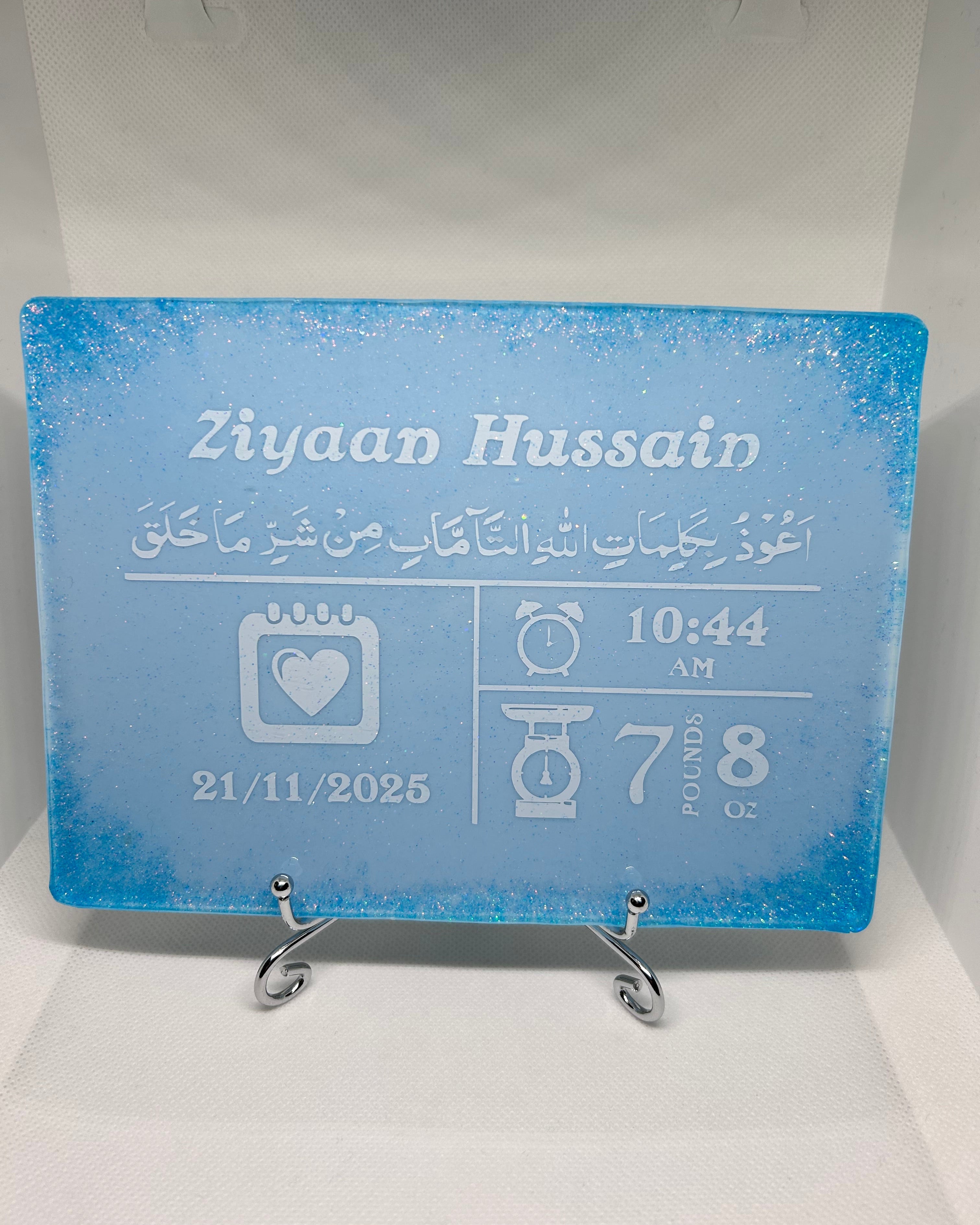 blue rectangle baby birth stat personalised resin plaque baby keepsake with personalised text in white and blue glitter in all for corner on a white background
