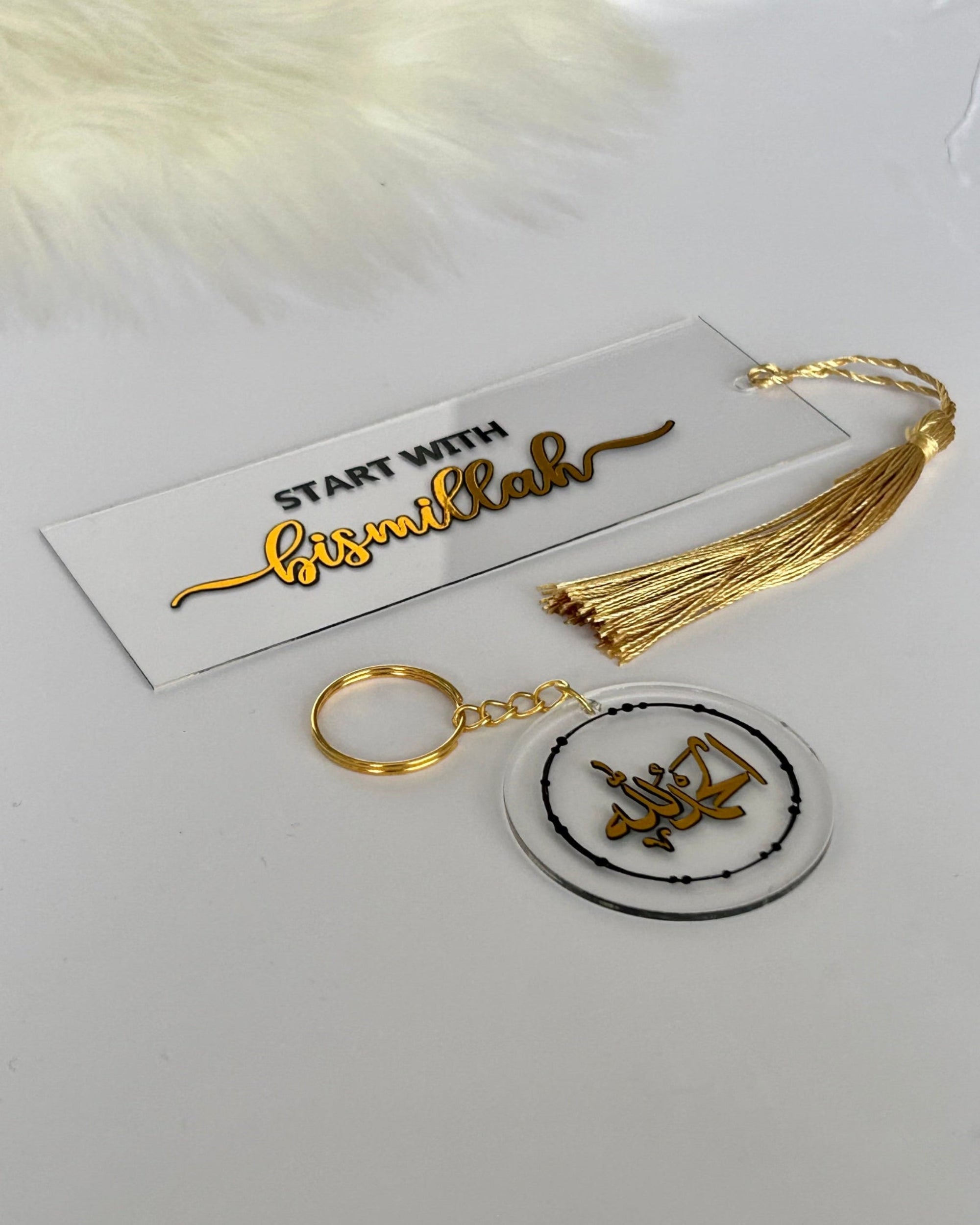 acrylic bookmarks with gold and black text on a white background
